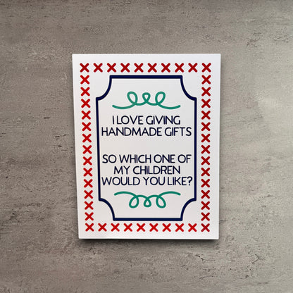 Impish Greetings handmade greeting card with funny text about giving away children, featuring red cross-stitch border