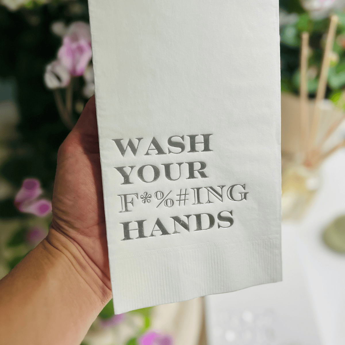 Impish Greetings paper guest towels with metallic gold foil text reading Wash Your F*%#ING Hands on white 3-ply paper