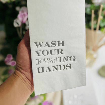 Impish Greetings paper guest towels with metallic gold foil text reading Wash Your F*%#ING Hands on white 3-ply paper