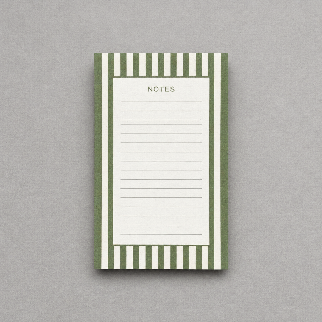 Impish Greetings green striped notepad with 75 lined tear-away pages for notes and to-do lists on a grey background.