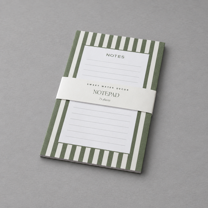 Impish Greetings green striped notepad with 75 lined tear-away pages and a branded paper band on a grey background