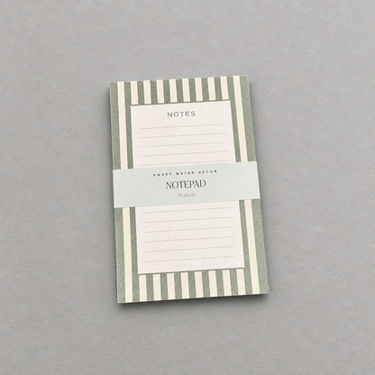 Impish Greetings green striped notepad with 75 lined tear-away pages for notes and to-do lists on a grey background.