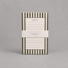 Impish Greetings green and white striped notepad with 75 lined tear-away pages for desk organization.