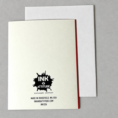 Back of Impish Greetings A2 greeting card featuring the Ink & Attitude logo and a white envelope on a grey background