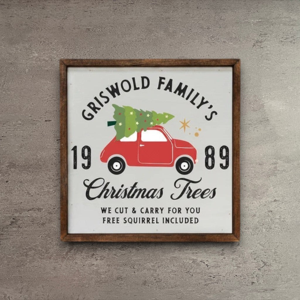 Impish Greetings rustic wood sign featuring a red car with a Christmas tree and Griswold Family text on a wood wall.