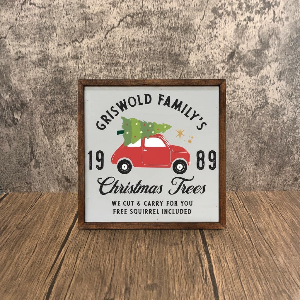 Impish Greetings rustic wood sign featuring a red car with a Christmas tree and Griswold family holiday text.