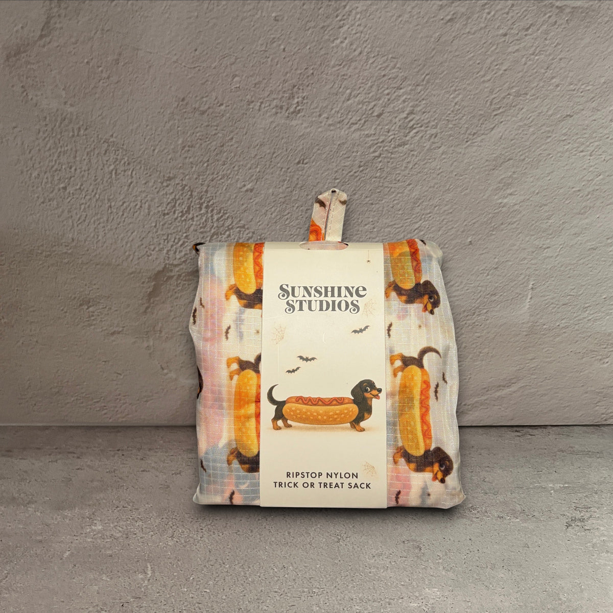 Impish Greetings Happy Halloweenie trick or treat sack folded in a pouch with a dachshund hot dog print