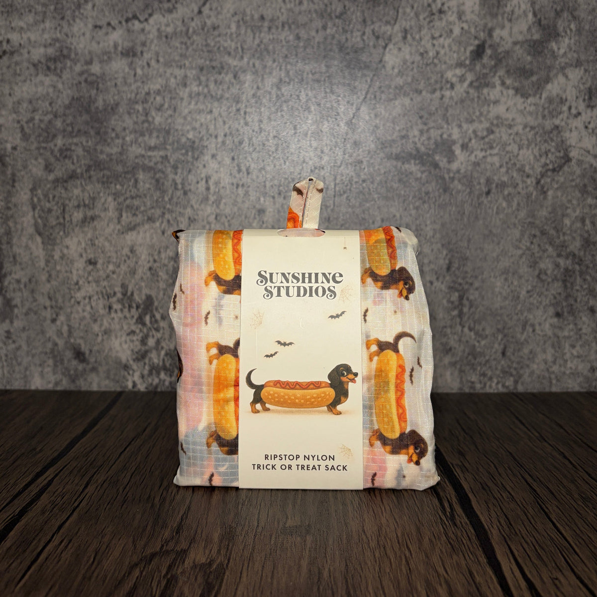 Impish Greetings Happy Halloweenie reusable ripstop nylon trick or treat sack folded in its integrated pouch