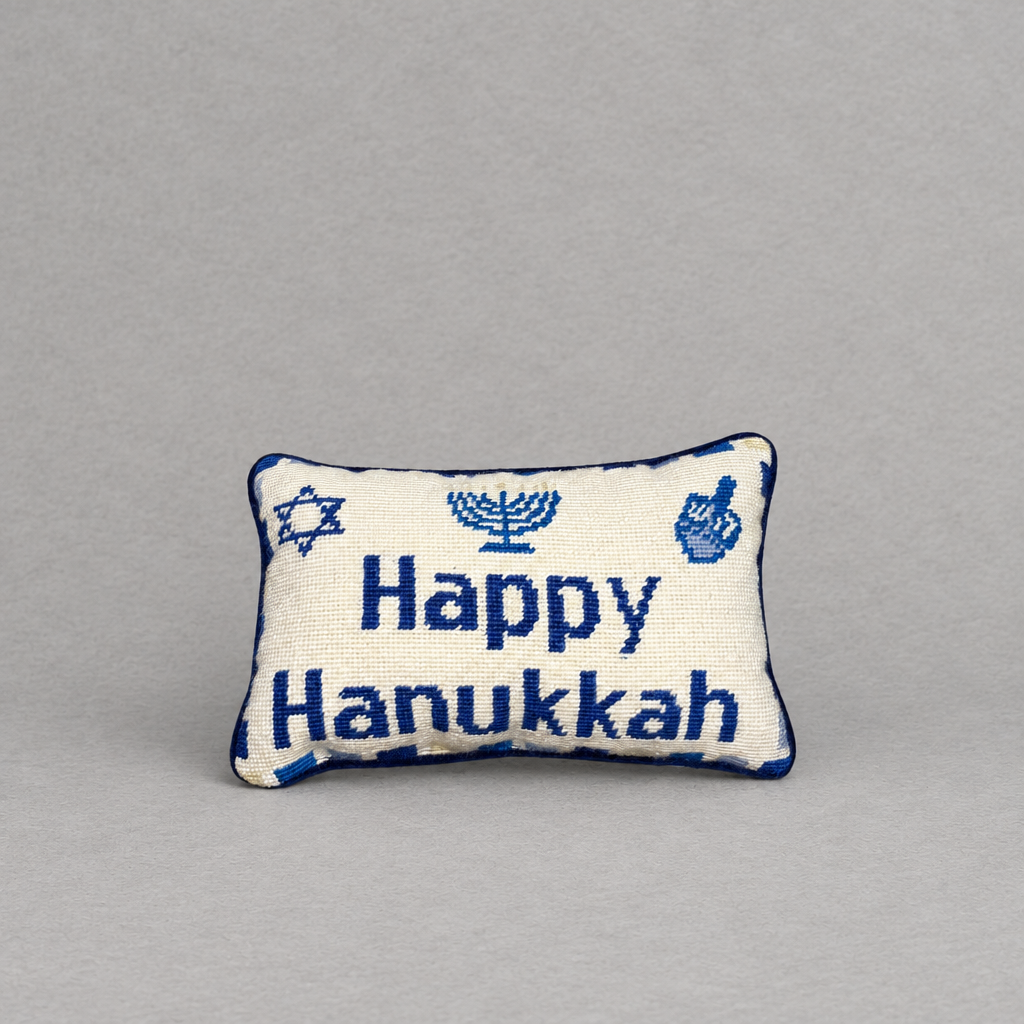 Impish Greetings Happy Hanukkah needlepoint pillow featuring blue menorah and dreidel motifs on a cream wool background