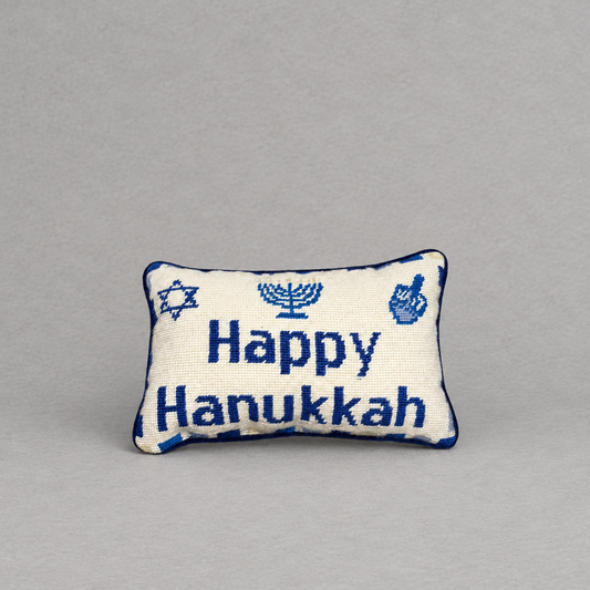 Impish Greetings Happy Hanukkah needlepoint pillow featuring blue menorah and dreidel motifs on a cream wool background