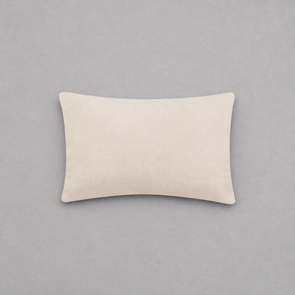 Impish Greetings Happy Hanukkah needlepoint pillow with a soft beige cotton velvet backing on a grey background.