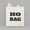 Impish Greetings Ho Bag canvas tote with bold black typography on natural cotton fabric against a grey background.