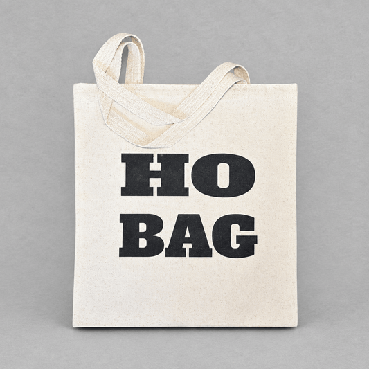 Impish Greetings Ho Bag canvas tote with bold black typography on natural cotton fabric against a grey background.