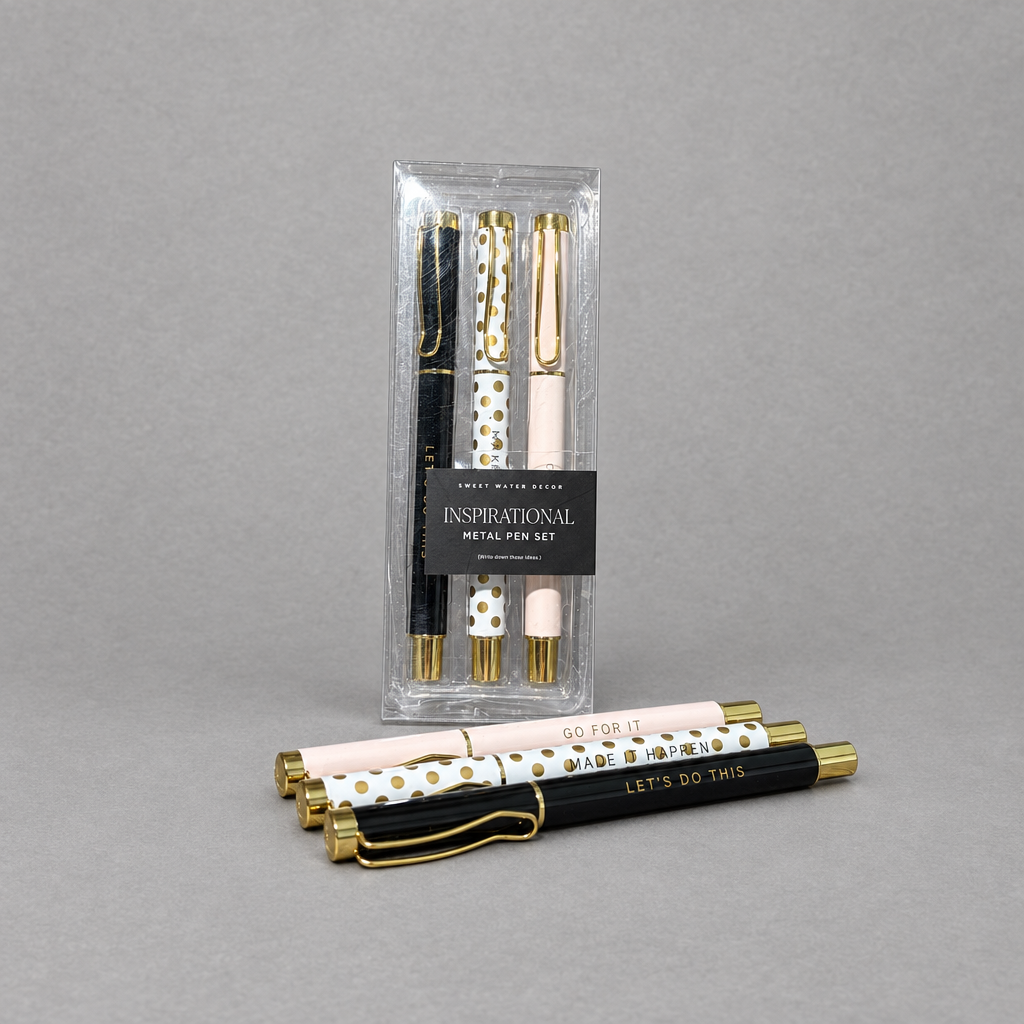 Impish Greetings set of three motivational metal ballpoint pens in light pink, black, and white with gold accents.