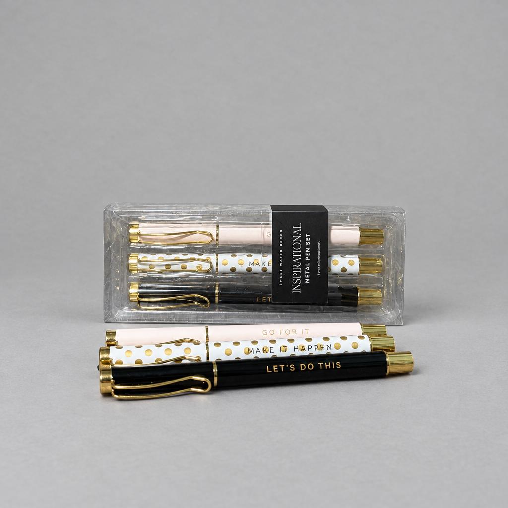 Impish Greetings set of three motivational metal ballpoint pens in light pink, white, and black with gold accents.