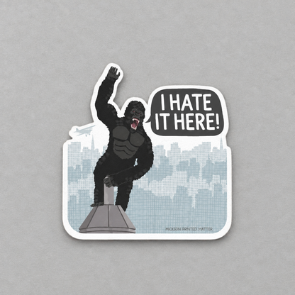 Impish Greetings I Hate It Here sticker featuring a King Kong illustration on a skyscraper with a speech bubble.