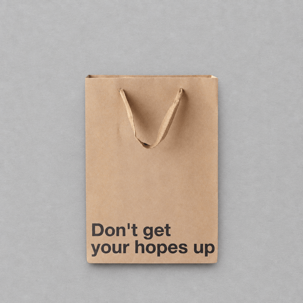Impish Greetings kraft paper gift bag with the text Don't get your hopes up printed in black on the front.