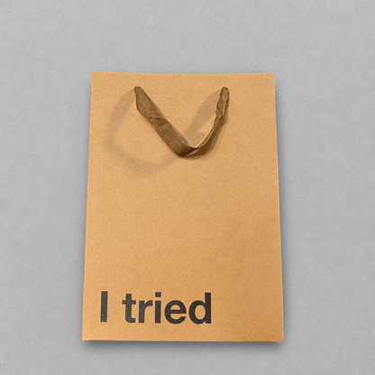Impish Greetings brown kraft paper gift bag with ribbon handles and the text I tried printed in black