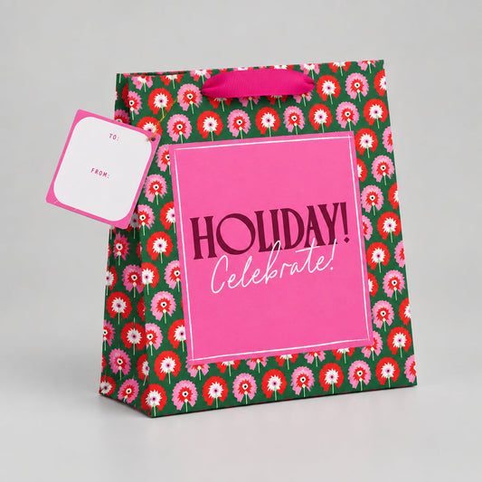 Impish Greetings large gift bag with green floral pattern, pink Holiday Celebrate label, and metallic ribbon handle.