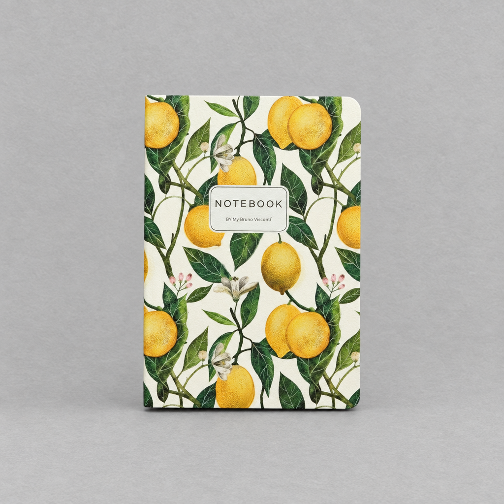 Impish Greetings A5 notebook featuring a vibrant watercolor lemon and green leaf pattern on a cream background.