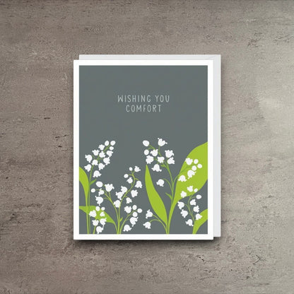 Impish Greetings sympathy card featuring white lily of the valley flowers on a grey background with comfort text