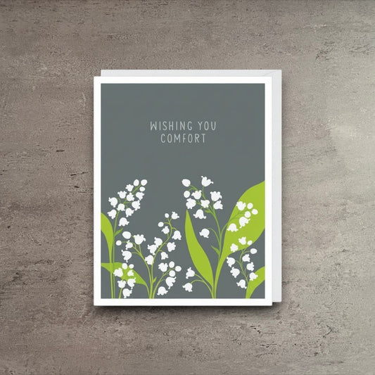 Impish Greetings sympathy card featuring white lily of the valley flowers on a grey background with comfort text