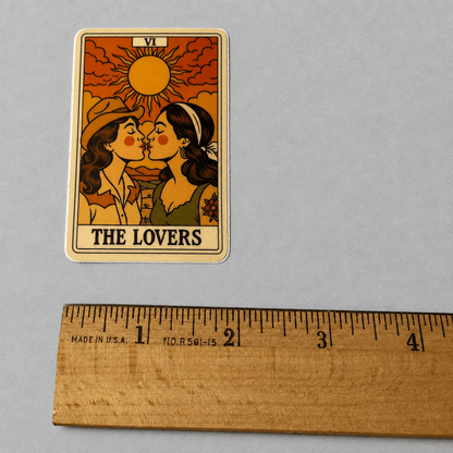Impish Greetings The Lovers tarot card sticker featuring two cowgirls kissing under a sun, matte vinyl design.