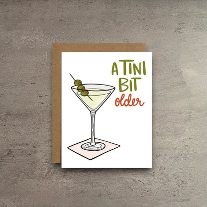Impish Greetings A Tini Bit Older birthday card featuring a martini illustration with olives on a kraft envelope.