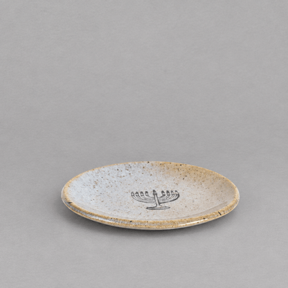Impish Greetings handmade ceramic stoneware mini plate with a speckled finish and a black menorah design.
