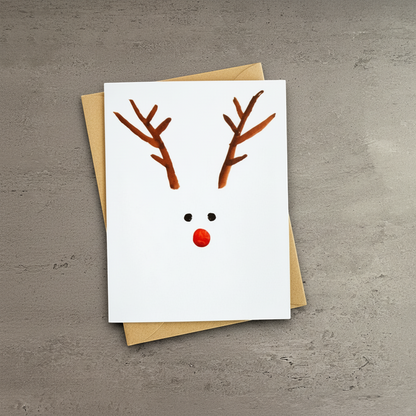 Impish Greetings minimalist holiday card featuring a watercolor reindeer design with a red nose and brown antlers.
