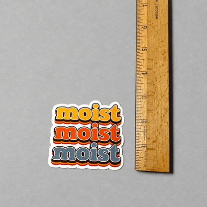 Impish Greetings vintage-style vinyl sticker featuring the word moist in stacked retro yellow, orange, and grey text.