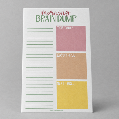 Impish Greetings Morning Brain Dump notepad with sections for top tasks, easy tasks, and next tasks on white paper.