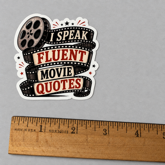 Impish Greetings I Speak Fluent Movie Quotes sticker with film reel design and glossy finish next to a wooden ruler.