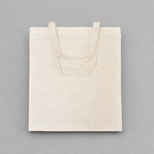 Impish Greetings Ho Bag natural cotton canvas tote bag with sturdy dual handles on a grey background