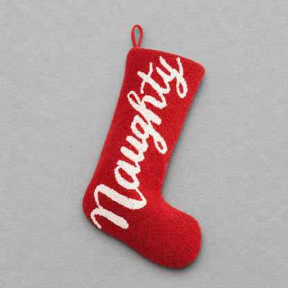 Impish Greetings red wool Christmas stocking with Naughty embroidered in white script text
