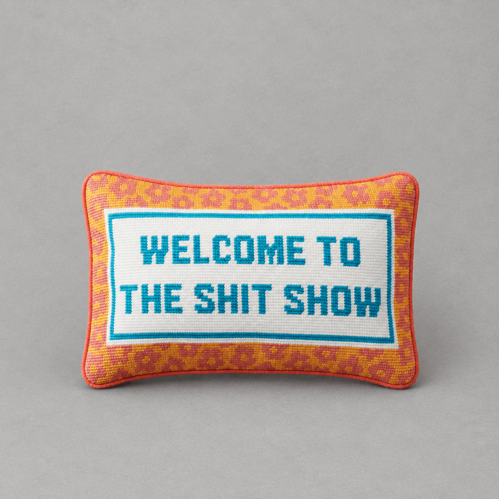 Impish Greetings needlepoint throw pillow with Welcome To The Shit Show text, orange leopard print, and blue border.