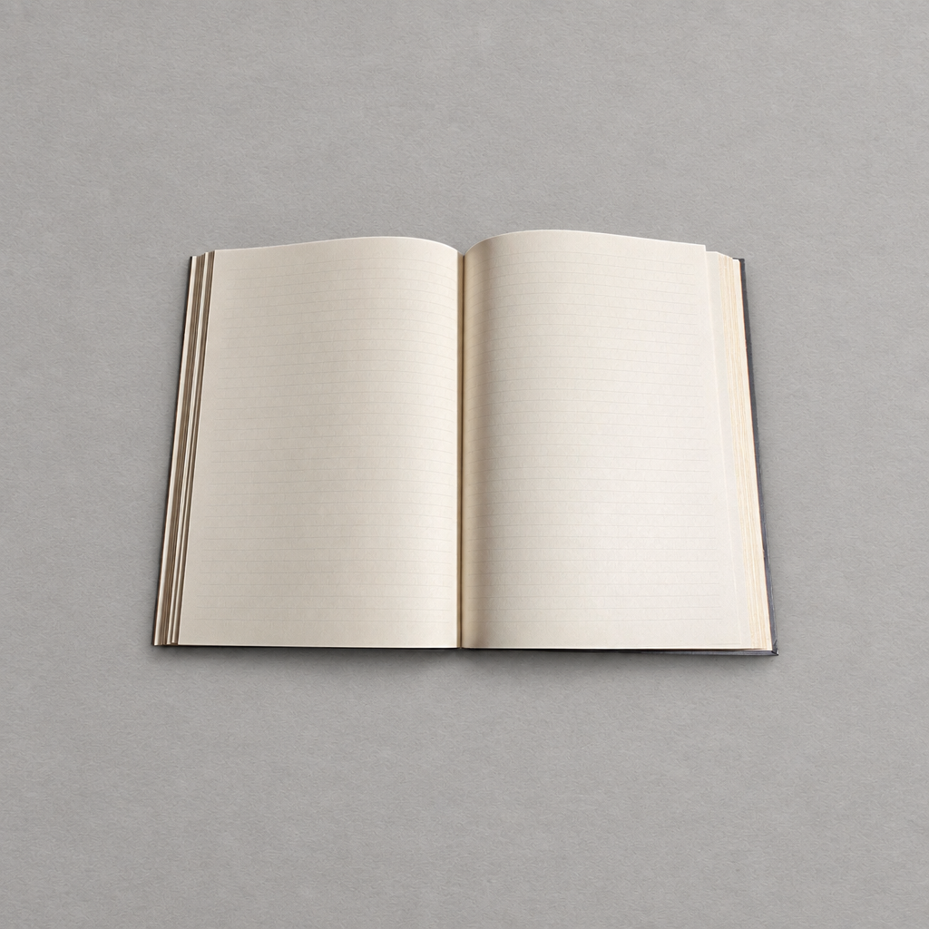 Impish Greetings Paperblanks Nocturnelle Grande journal open to lined cream pages on a neutral grey background
