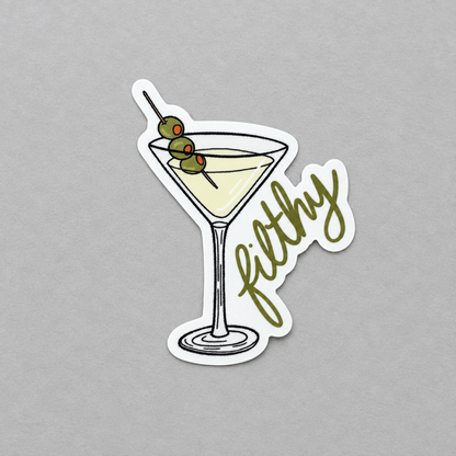 Impish Greetings glossy vinyl sticker featuring a martini glass with three olives and the word Filthy in script.