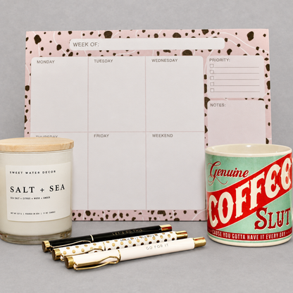 Impish Greetings Order from Chaos Bundle featuring a weekly planner, Coffee Slut mug, three gold pens, and a candle.