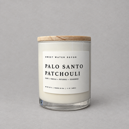 Impish Greetings 11 oz soy candle with Palo Santo and Patchouli scent in a glass jar with a wooden lid