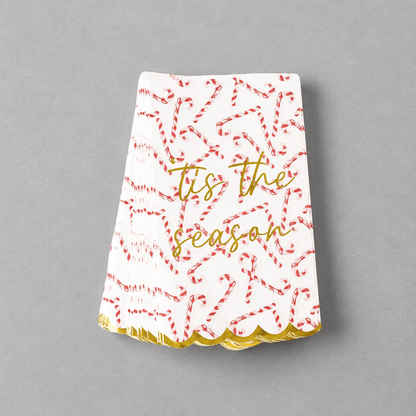 Impish Greetings peppermint toile paper guest towels with candy cane print, gold foil text, and scalloped gold edges.