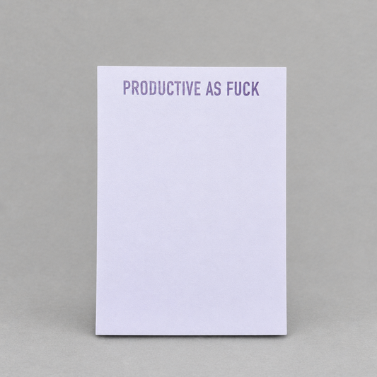 Impish Greetings Productive As Fuck notepad with purple text on a light purple paper background.