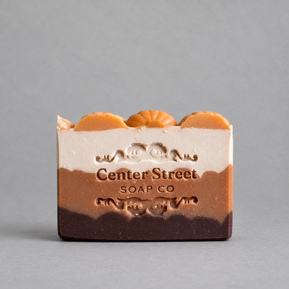Impish Greetings handmade pumpkin spice bar soap with layered earthy tones and decorative pumpkin top accents.