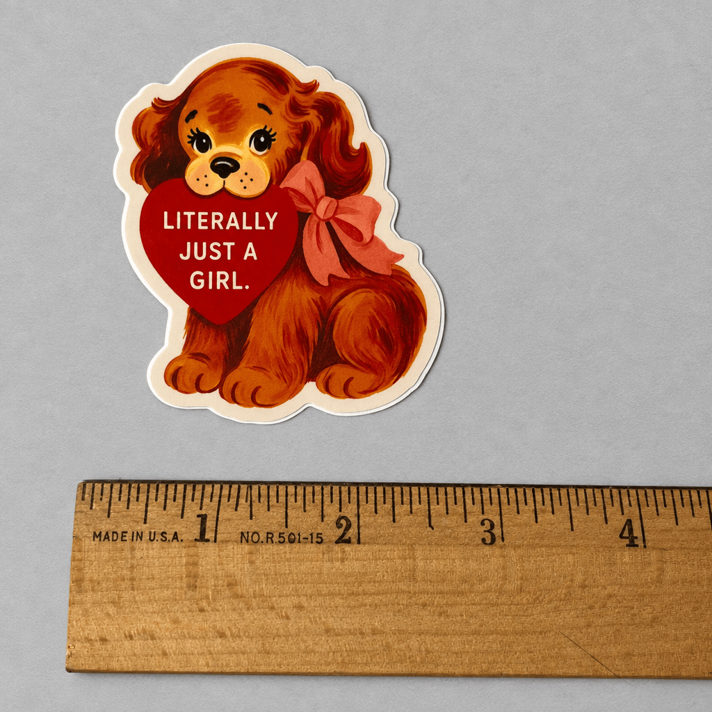 Impish Greetings Literally Just a Girl vinyl puppy sticker with a red heart and bow on a grey background.