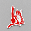 Impish Greetings red vinyl cat sticker featuring a cat in a humorous pose on a grey background.