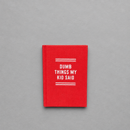 Impish Greetings red felt tiny diary with white text for recording funny things kids say, hard-bound with gold edges.