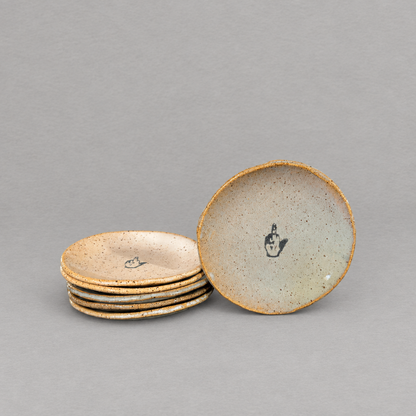 Impish Greetings handcrafted ceramic mini plates with a speckled glaze and a middle finger illustration