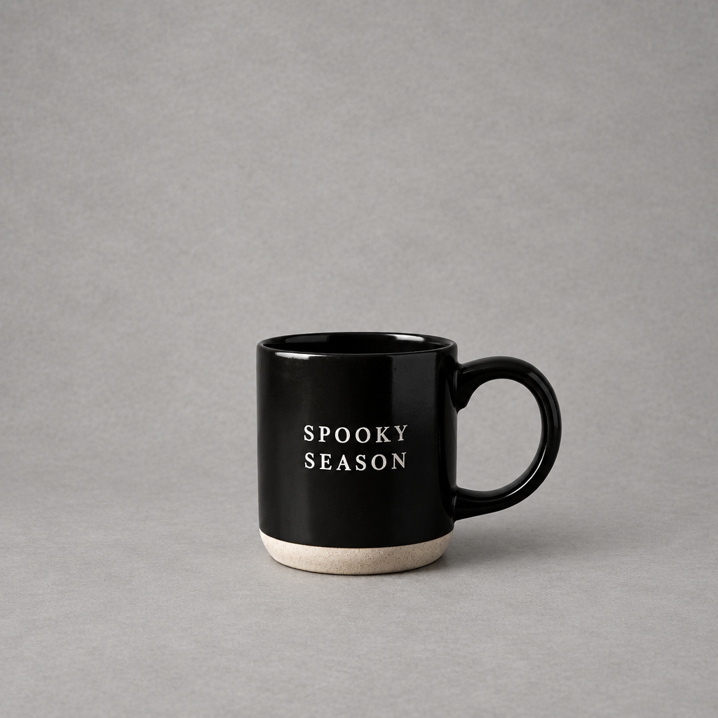 Impish Greetings black stoneware coffee mug with Spooky Season text and a natural speckled base