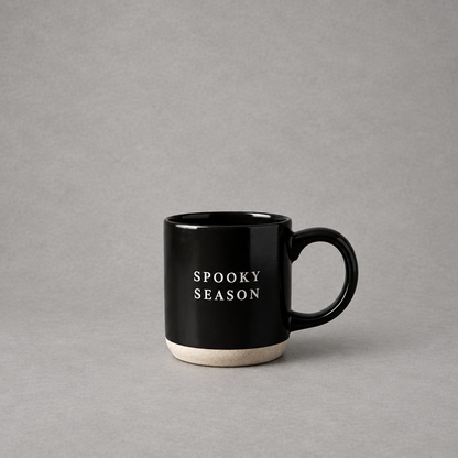 Impish Greetings black stoneware coffee mug with Spooky Season text and a natural speckled base