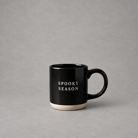 Impish Greetings black stoneware coffee mug with Spooky Season text and a natural speckled base